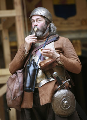 Falstaff in medieval battle gear licks a spoon of ice cream